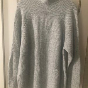 A High neck grey sweater. Great for COLD WEATHER...
